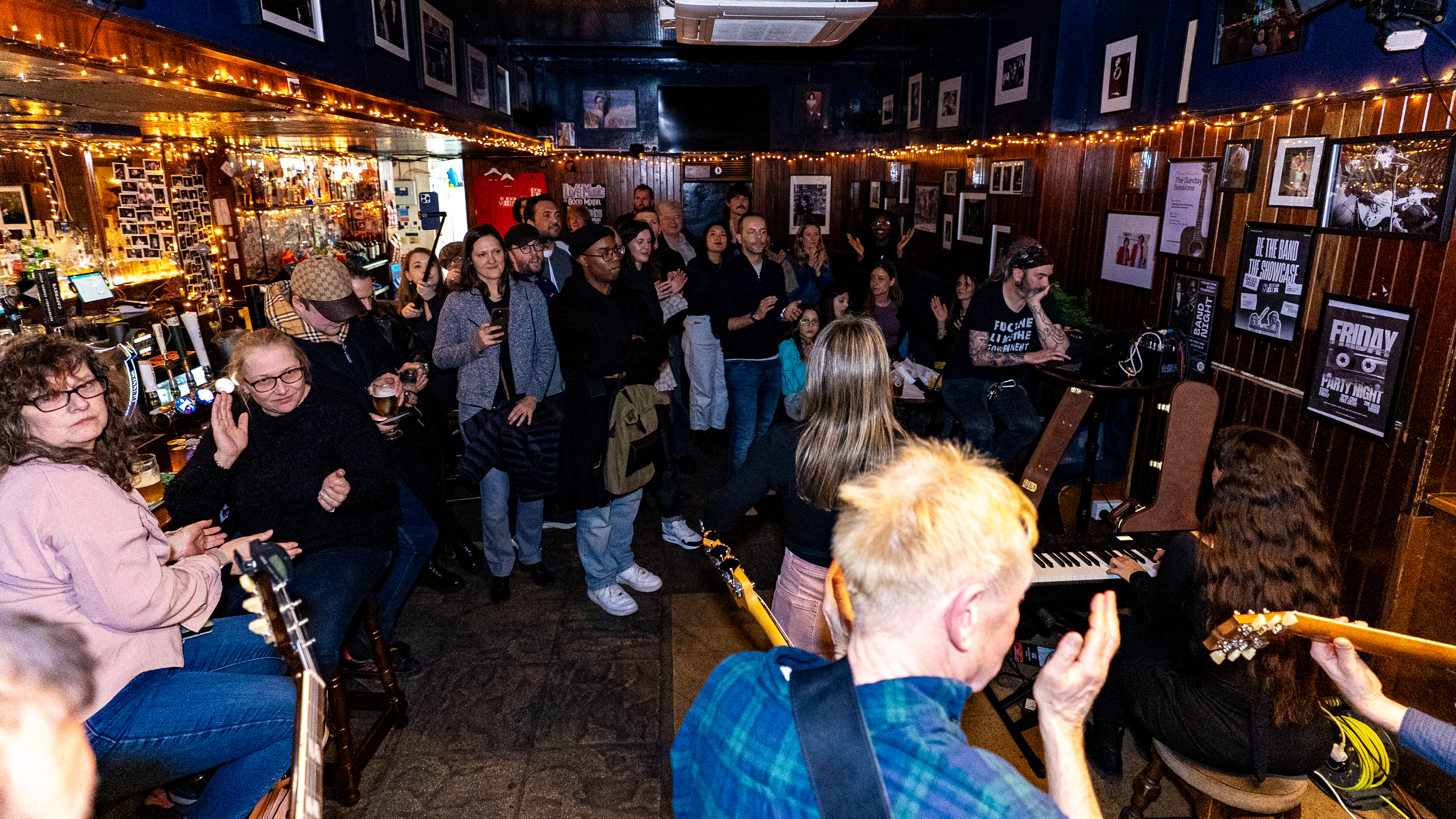 BetheBand members performing live on stage at an iconic London venue