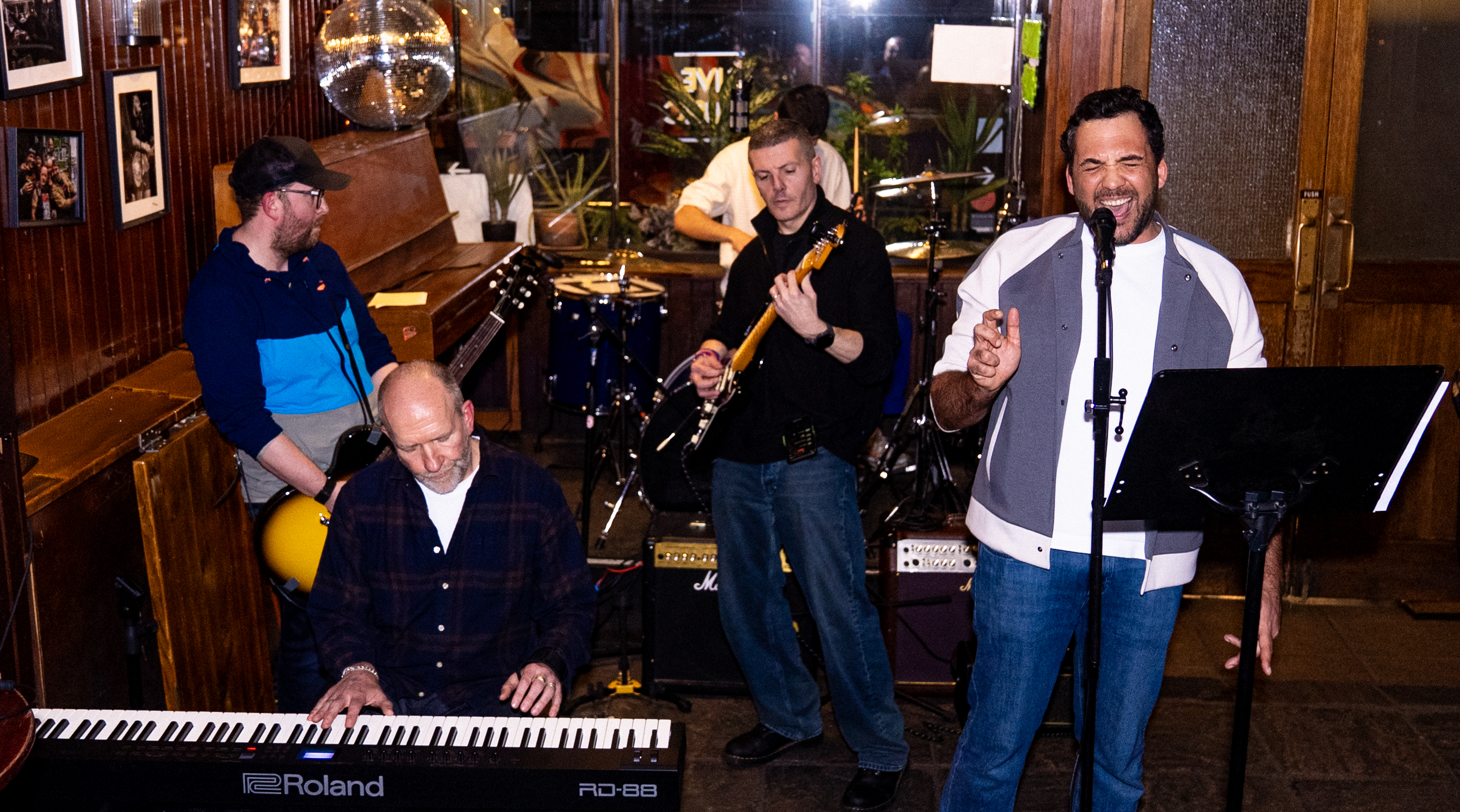 Adult musicians performing live on stage